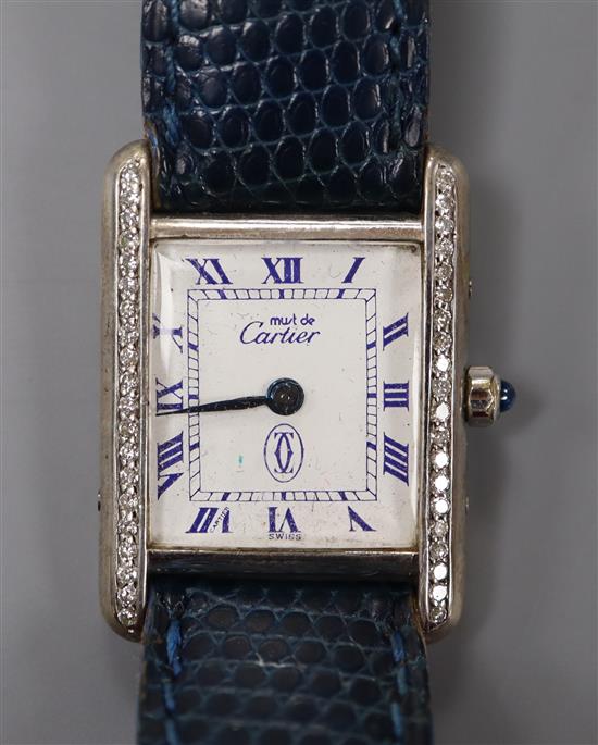 A ladys sterling Must de Cartier quartz rectangular wrist watch with diamond set bezel, in Cartier box.